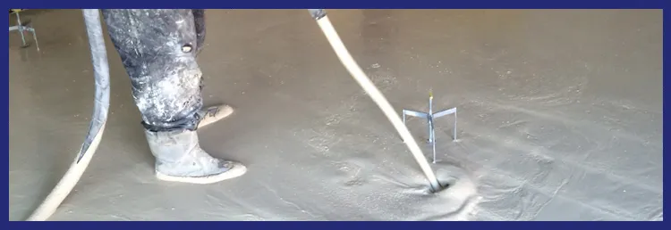 Liquid screed being levelled with a dappling bar