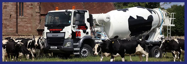 A cow-patterned TG Concrete mixer truck in a field of cattle