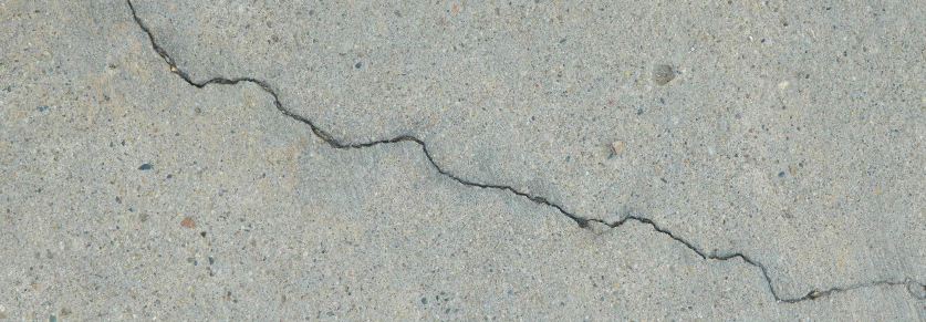 A hairline crack running across a concrete surface